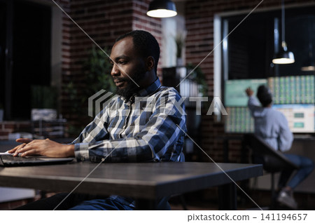 Investment employee reviewing portfolio documents highlighting and reviewing investors documentation and portfolio, Financial advisor analyzing forex stock market trend while sitting at desk. Investment employee reviewing portfolio documents highlighting and reviewing investors documentation and portfolio, Financial advisor analyzing forex stock market trend while sitting at desk. 141194657