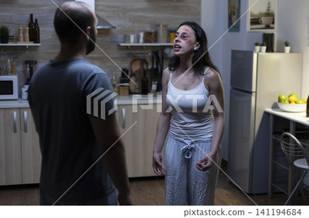 Couple faces aggressive relationship argument at home, linking fear, bruises and relationship trauma in a realistic family conflict context. Couple faces aggressive relationship argument at home, linking fear, bruises and relationship trauma in a realistic family conflict context. 141194684