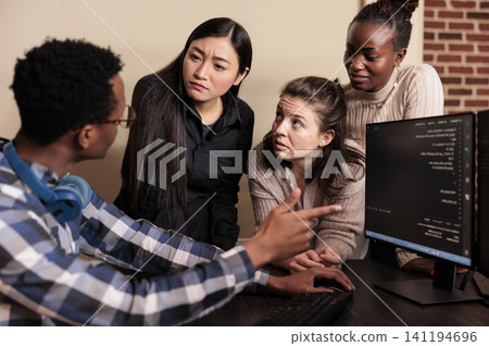 Diverse developers program business application, diverse software developers programming application, typing html code on computer. Diverse developers program business application, diverse software developers programming application, typing html code on computer. 141194696
