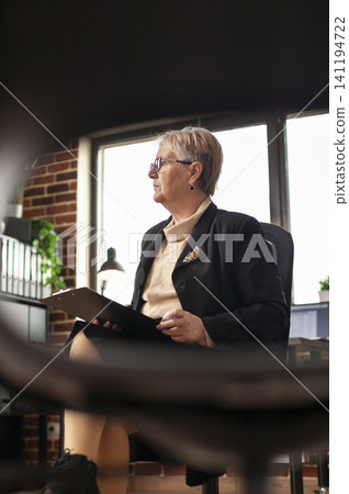 Close up of psychiatrist preparing for aa meeting with people, looking around. Psychologist thinking about group therapy session, sitting in circle with chairs to help with addiction. Close up of psychiatrist preparing for aa meeting with people, looking around. Psychologist thinking about group therapy session, sitting in circle with chairs to help with addiction. 141194722