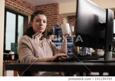 Software developer writing html code on computer, sitting at desk parsing algorithm in it programming agency, Tech enginners working on app developing program. Software developer writing html code on computer, sitting at desk parsing algorithm in it programming agency, Tech enginners working on app developing program. 141194785