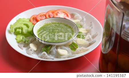 shrimp in fish sauce with Thai spicy seafood dipping sauce on white plate and umeshu shrimp in fish sauce with Thai spicy seafood dipping sauce on white plate and umeshu 141195387