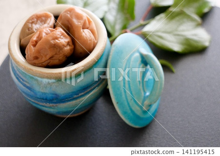 Homemade pickled plums and plum leaves in a jar Homemade pickled plums and plum leaves in a jar 141195415