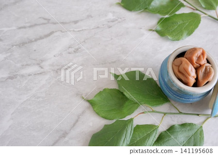 Homemade pickled plums and plum leaves (copy space) Homemade pickled plums and plum leaves (copy space) 141195608