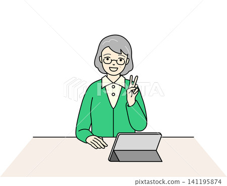 A senior woman smiles and makes a peace sign in front of a tablet. A senior woman smiles and makes a peace sign in front of a tablet. 141195874