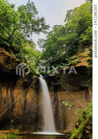 The magnificent Shichijo Falls boasts lush green foliage atop a cliff and a powerful, cascading waterfall. The magnificent Shichijo Falls boasts lush green foliage atop a cliff and a powerful, cascading waterfall. 141196203