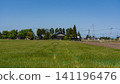 A large Japanese-style house (Azumadachi) with a traditional grove of trees (Kainyo) standing in the Tonami Plain of Toyama Prefecture. 141196476