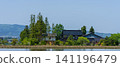 A large Japanese-style house (Azumadachi) with a traditional grove of trees (Kainyo) standing in the Tonami Plain of Toyama Prefecture. 141196479