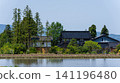 A large Japanese-style house (Azumadachi) with a traditional grove of trees (Kainyo) standing in the Tonami Plain of Toyama Prefecture. 141196480