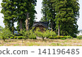 A large Japanese-style house (Azumadachi) with a traditional grove of trees (Kainyo) standing in the Tonami Plain of Toyama Prefecture. 141196485