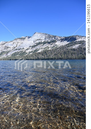 Crystal clear waters of Tenaya Lake framed by a massive granite dome mountain. Crystal clear waters of Tenaya Lake framed by a massive granite dome mountain. 141196615