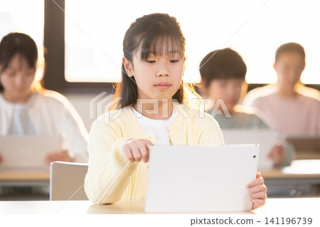 Children using tablets to take lessons at cram school. Children using tablets to take lessons at cram school. 141196739