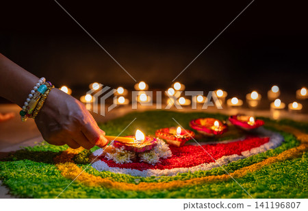Clay diya lamps lit during diwali celebration, Diwali, or Deepavali, is India's biggest and most important holiday. Clay diya lamps lit during diwali celebration, Diwali, or Deepavali, is India's biggest and most important holiday. 141196807