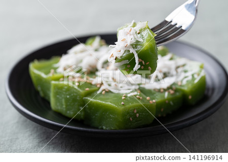 Traditional Thai dessert, pandan sweet pudding topped with coconut and toasted sesame seeds  141196914