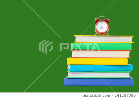 Colorful books and a red clock signal back to school Colorful books and a red clock signal back to school 141197396