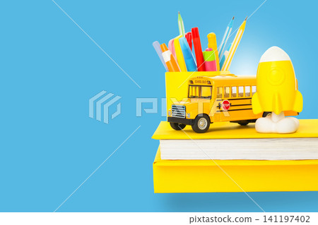 Colorful supplies and a yellow bus signify the start of school Colorful supplies and a yellow bus signify the start of school 141197402
