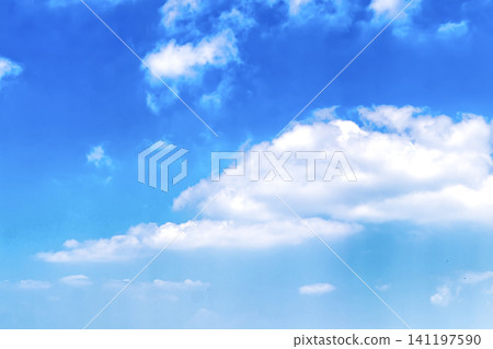 Bright blue sky with fluffy white cumulus clouds on a clear summer day Bright blue sky with fluffy white cumulus clouds on a clear summer day 141197590