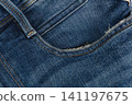 Closeup of denim jeans pocket showing stitching and fabric texture 141197675