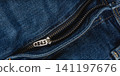 Closeup view of denim jeans showcasing pocket and zipper details 141197676