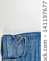Closeup view of denim jeans pocket on plain background with space 141197677