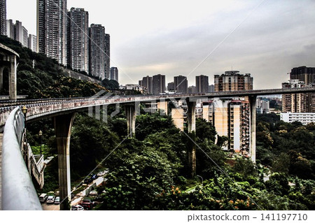 Chongqing cityscape with elevated highway bridge and residential skyscrapers on hillside Chongqing cityscape with elevated highway bridge and residential skyscrapers on hillside 141197710