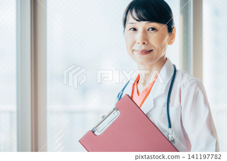 Female doctor working in a hospital Female doctor working in a hospital 141197782