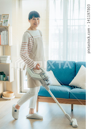 Midwomen wearing a vacuum cleaner Midwomen wearing a vacuum cleaner 141197803