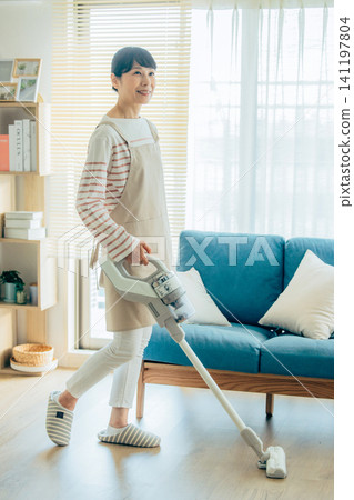Midwomen wearing a vacuum cleaner Midwomen wearing a vacuum cleaner 141197804