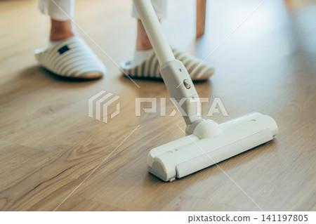 Midwomen wearing a vacuum cleaner 141197805