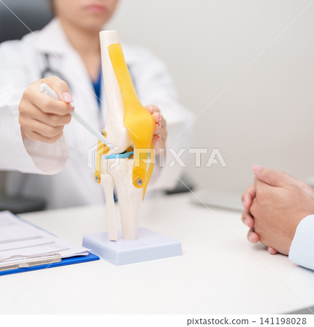 Doctor with Human Knee joint anatomy model. Osteoarthritis, Patellofemoral Pain Syndrome, Patellar Tendinitis, ACL, Anterior Cruciate Ligament, PCL, Posterior, MCL, Medial Collateral, LCL and Lateral Doctor with Human Knee joint anatomy model. Osteoarthritis, Patellofemoral Pain Syndrome, Patellar Tendinitis, ACL, Anterior Cruciate Ligament, PCL, Posterior, MCL, Medial Collateral, LCL and Lateral 141198028