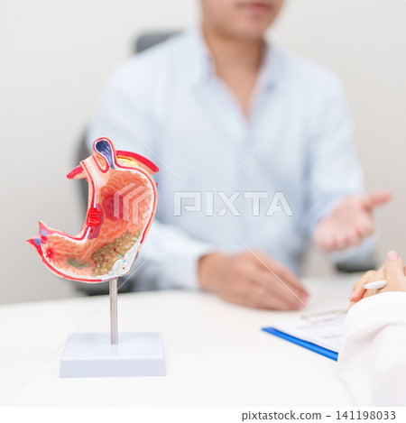 Doctor with Gastric anatomy model. Gastroenterologist consultation, stomach diseases and ulcers, November stomach cancer, Gastroesophageal Reflux Disease, GERD, Acid reflux and healthcare medical Doctor with Gastric anatomy model. Gastroenterologist consultation, stomach diseases and ulcers, November stomach cancer, Gastroesophageal Reflux Disease, GERD, Acid reflux and healthcare medical 141198033