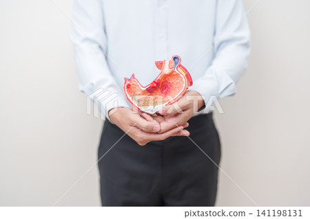 Man having abdomen pain or Stomachache with Gastric anatomy model. stomach diseases and ulcers, Gastroesophageal Reflux, November stomach cancer, Gastroenterologist consultation and Acid reflux Man having abdomen pain or Stomachache with Gastric anatomy model. stomach diseases and ulcers, Gastroesophageal Reflux, November stomach cancer, Gastroenterologist consultation and Acid reflux 141198131