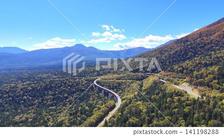 The breathtaking autumn scenery of Mikuni Pass and Matsumi Ohashi Bridge | A road cutting through a vast forest | A magnificent panorama of Hokkaido The breathtaking autumn scenery of Mikuni Pass and Matsumi Ohashi Bridge | A road cutting through a vast forest | A magnificent panorama of Hokkaido 141198288