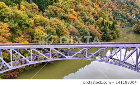 The magnificent view of the Tadami Line's First Bridge, surrounded by deep gorges and stunning autumn foliage. The magnificent view of the Tadami Line's First Bridge, surrounded by deep gorges and stunning autumn foliage. 141198304