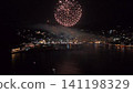 Aerial view of Atami's nightscape, with large red fireworks and the lights reflected on the sea surface. Aerial view of Atami's nightscape, with large red fireworks and the lights reflected on the sea surface. 141198329
