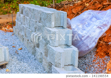 Construction site stacked concrete blocks during assemble retaining wall Construction site stacked concrete blocks during assemble retaining wall 141198554