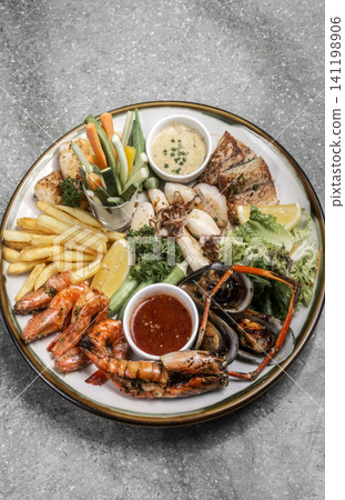 mixed mediterranean fish and seafood assortment plate on spanish restaurant table mixed mediterranean fish and seafood assortment plate on spanish restaurant table 141198906