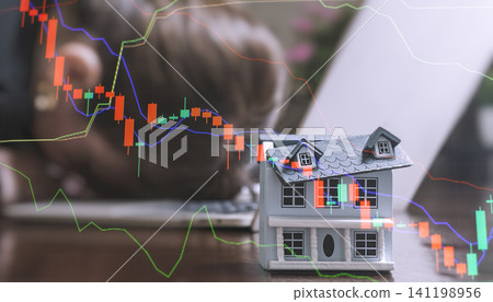 Housing bubble burst and mortgage crisis. Downward red stock graphs over a model home with a depressed person on a laptop. Housing bubble burst and mortgage crisis. Downward red stock graphs over a model home with a depressed person on a laptop. 141198956