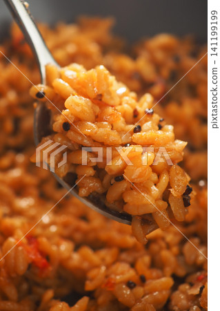 The dish typically features long-grain rice cooked in a sauce made from blended tomatoes, red bell peppers, onions The dish typically features long-grain rice cooked in a sauce made from blended tomatoes, red bell peppers, onions 141199199