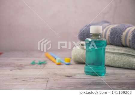 Mint mouthwash, towels, and toothbrushes on counter Mint mouthwash, towels, and toothbrushes on counter 141199203