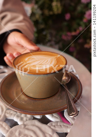 Coffee is served at a cafe with a warm atmosphere Coffee is served at a cafe with a warm atmosphere 141199204