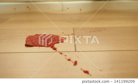 Red substance spills on wooden floor at a home 141199209