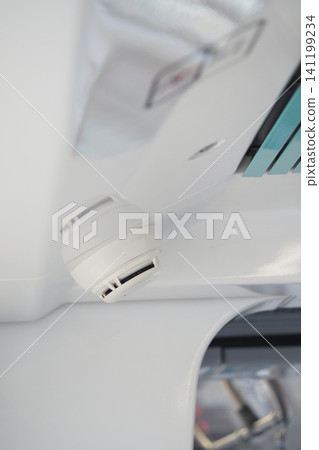 Smoke detector near a white ceiling in a building Smoke detector near a white ceiling in a building 141199234