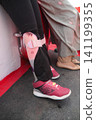 child worn Colorful leg brace paired with sneakers at an outdoor 141199355