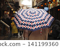 Colorful umbrella in a busy market during rainy weather 141199360