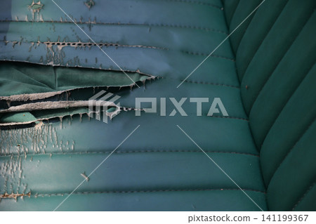 Worn leather reveals history of use in vintage chair Worn leather reveals history of use in vintage chair 141199367