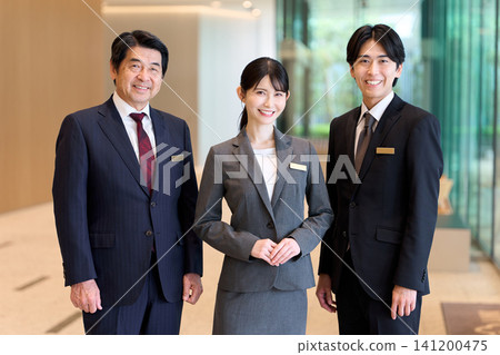 Asian hotel staff standing at the entrance Asian hotel staff standing at the entrance 141200475