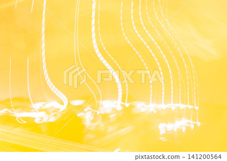 Abstract yellow light trails glowing curved lines long exposure motion creating vibrant luminous background suitable for modern creative technology design themes Abstract yellow light trails glowing curved lines long exposure motion creating vibrant luminous background suitable for modern creative technology design themes 141200564
