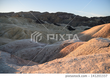 Majestic sierra nevada mountain towers above rugged desert landscape with dry rock formation and rolling sand hill conveying serene emotion under soft morning sunlight Majestic sierra nevada mountain towers above rugged desert landscape with dry rock formation and rolling sand hill conveying serene emotion under soft morning sunlight 141201337