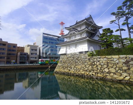The Ushitora Turret (former Taiko Turret site) at Takamatsu Castle Ruins (Tamamo Castle Ruins/Tamamo Park) and a train of the Takamatsu Kotohira Electric Railway - Takamatsu City, Kagawa Prefecture 141201672